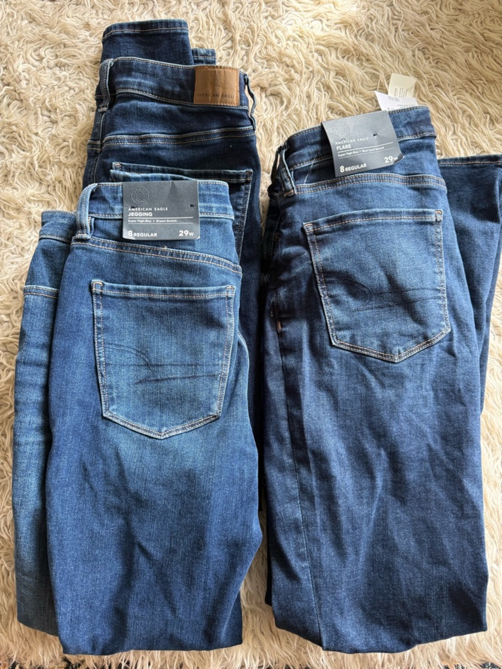 2 American Eagle Outfitters Women’s Dark Blue Skinny Jeans and  1 Flares.